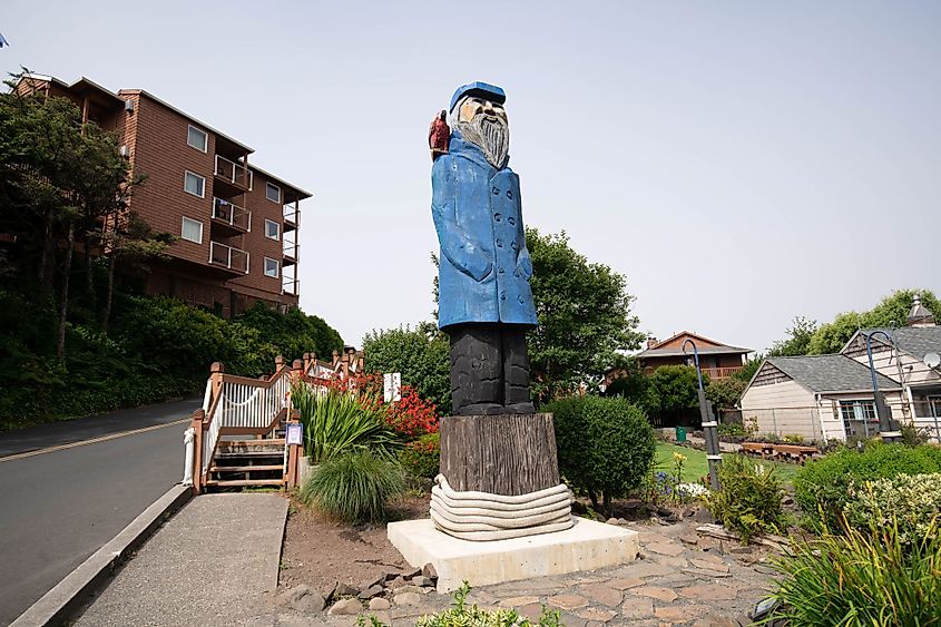 Wooden statue of the Asian captain with a parrot on the main street in Cannon Beach, Oregon