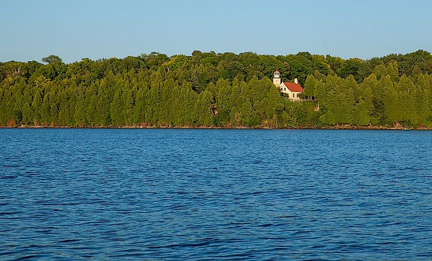 Eagle Point Lighthouse and Peninsula State Park shot from the water on boat.