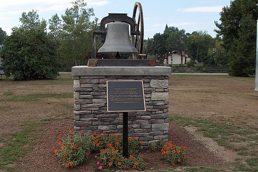 Tower Bell of Putnam, Connecticut with flowers at the base.