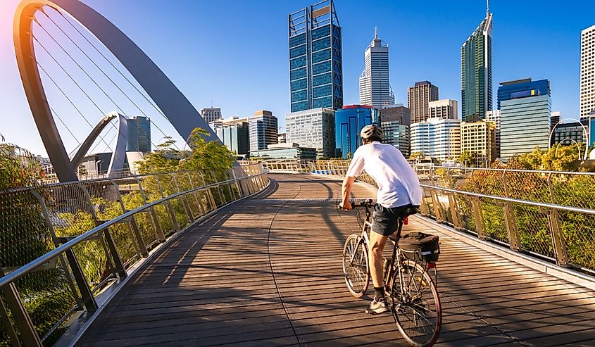A man cycling on the Elizabeth Bridge in Perth city, Western Australia.