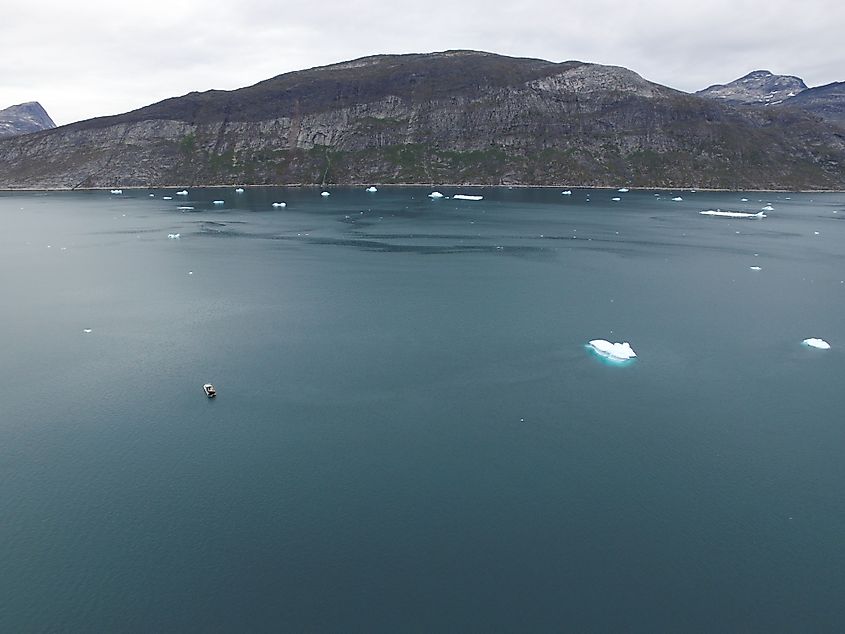 Drone aerial images of melting icebergs drifting in a fjord in Greenland.