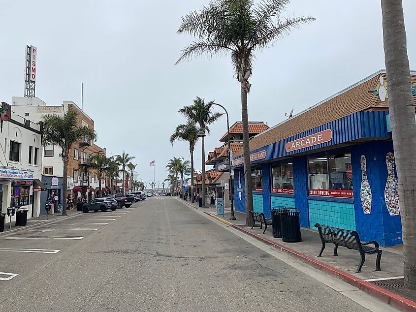 Palm trees, an arcade, and restaurants line the way down to Pismo Beach’s pier.