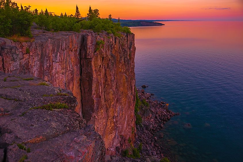 The cliffs of Palisade Head towering over Lake Superior at sunset. Tettegouche State Park, Minnesota.