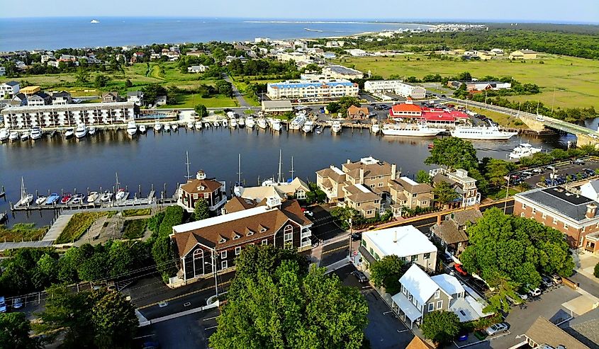 The aerial view of the beach town, fishing port and waterfront residential homes along the canal