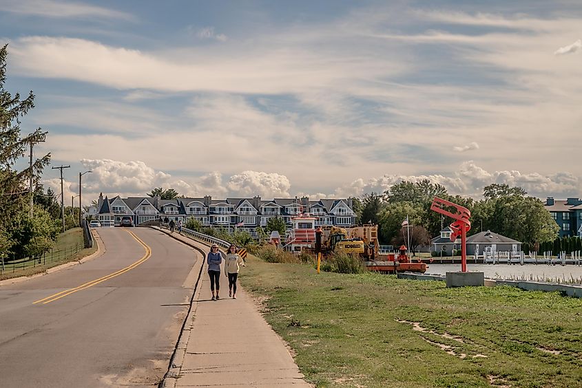 People explore the beach and harbor area in the town in summer, via Page Light Studios / Shutterstock.com