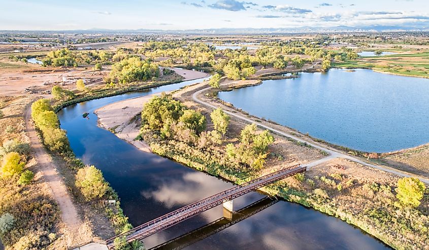 aerial view of South Platte River with bike trails around a brown landscape dotted with trees