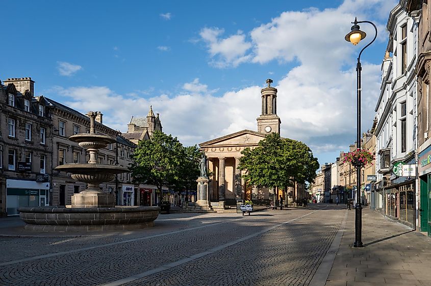 High Street, Elgin, Moray, Scotland: A view across the Plainstones area toward St. Giles Church on a sunny summer evening.