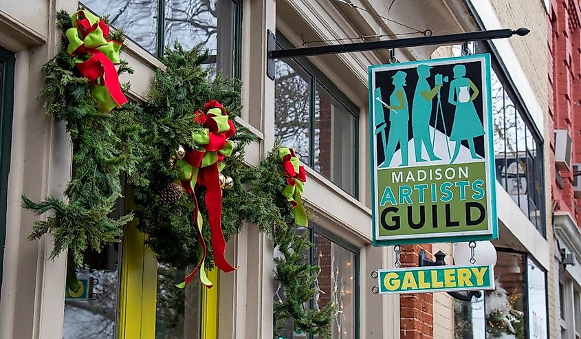 The front entrance of the Madison Artists Guild gallery decorated with festive garland and lights for the Christmas shopping season in Madison, Georgia.