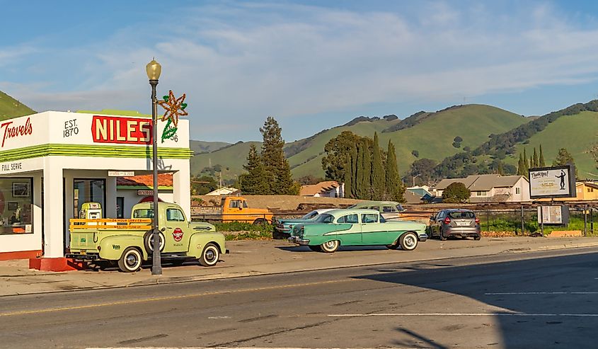 Oldsmobile and Ford pickup truck at a gas station. Retro car on the main street of Niles, California.