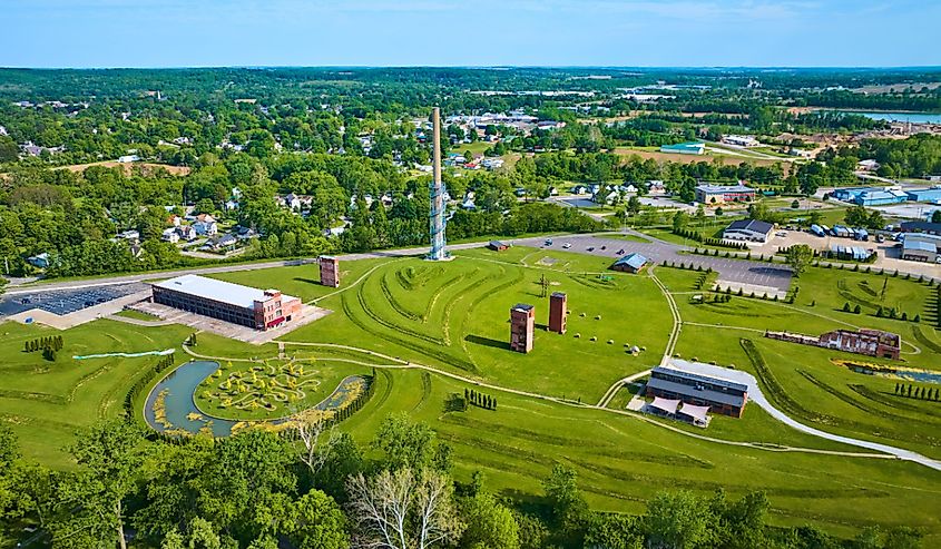 Distant city of Mount Vernon Ohio in drone view of destroyed factory at Ariel Foundation Park trails