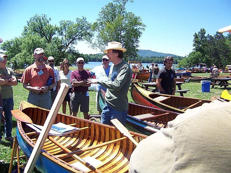 Benson Gray, a descendant of the founders of Old Town Canoe, leads a tour of canoes on the green at the Annual Assembly of the Wooden Canoe Heritage Association, which featured Old Town's contributions to canoeing in 2012.