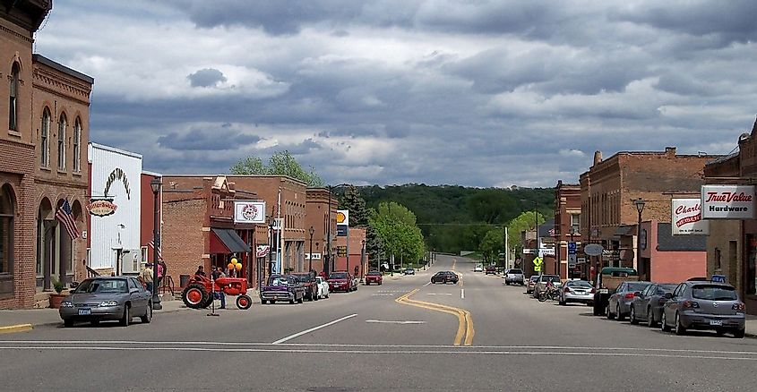 Downtown Henderson, Minnesota streets with a tractor and vehicles parked.