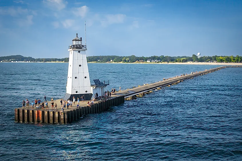 People gather at the North Pier Lighthouse, dating back to 1924, on Lake Michigan