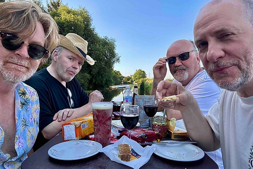Four friends on the stern of a narrowboat at dusk. Image credit: Bryan Dearsley