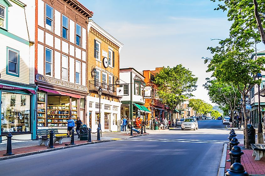 Main street in the downtown village of Bar Harbor, USA, bustling with people and stores on a summer day.