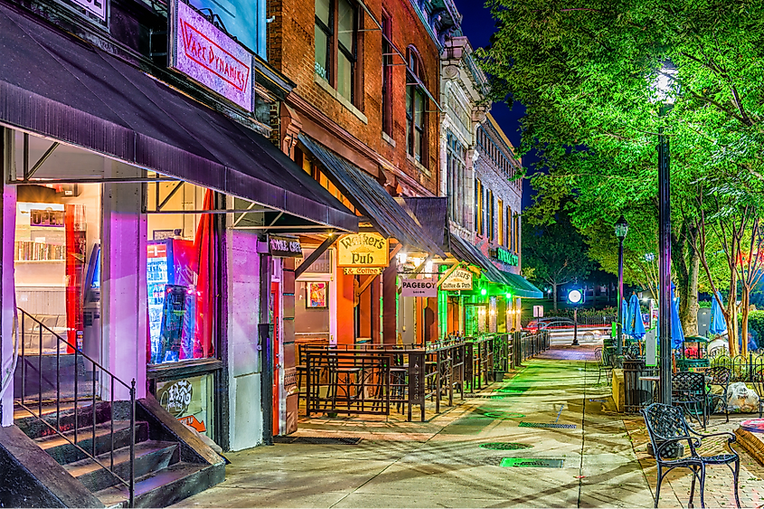 Shops and bars along College Avenue in downtown Athens at night.