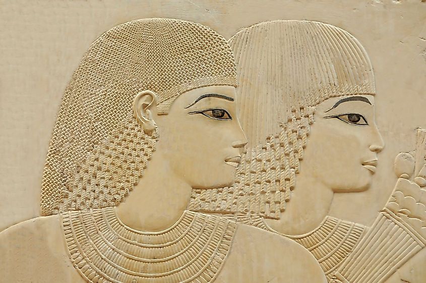 Portrait of a beautiful young couple with eye makeup in an ancient egyptian tomb.