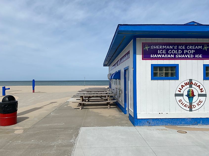 An empty beachside concession stand on an overcast day.