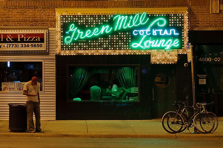 Chicago, Illinois - July 16, 2012: A man checks his phone while standing in front of the famous Green Mill Cocktail Lounge in Chicago, Illinois. (9170)