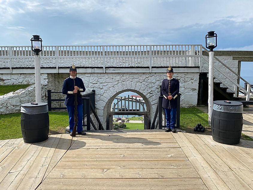 Soldiers dressed in 1812 attire guard the entrance to Mackinac Island's hilltop fort. 