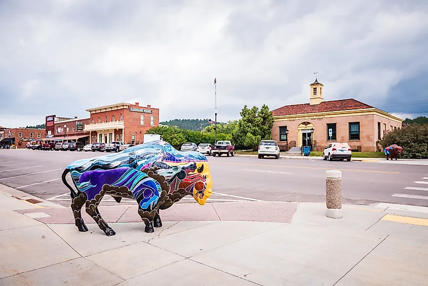 The beautiful downtown of Custer, South Dakota, with a colorful symbolic bison (buffalo) statue.