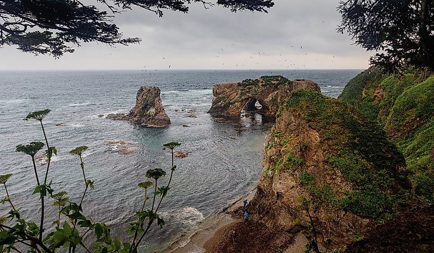 Picturesque Cape Velikan on the shore of the Sea of ​​Okhotsk in the Far East of Russia, Sakhalin Island. Picturesque coastal cliffs and the sea.