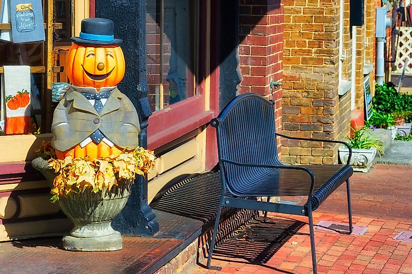 Jonesborough,Tennessee,USA - October 24th, 2018: A happy jack-o-lantern statue adorns the steps leading into a store on main street, via Dee Browning / Shutterstock.com