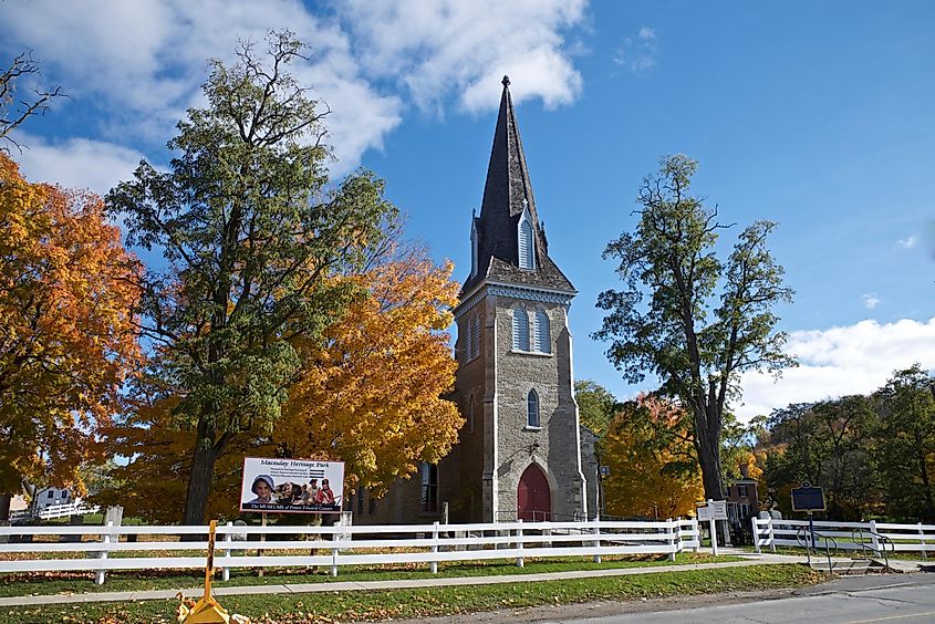 Picton, Ontario, Canada: The exterior of a historic Heritage Catholic Church building with autumn leaf colors.