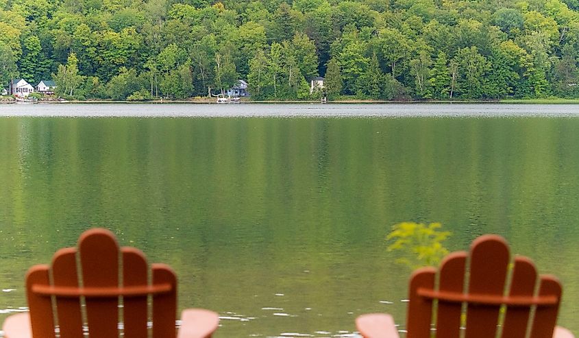 Adirondack chairs overlooking Crystal Lake in Barton Vermont