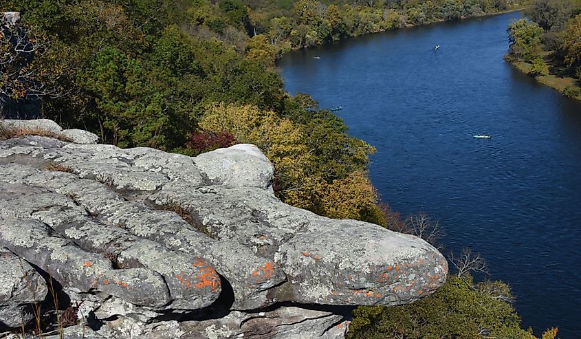 Rock formation almost looks like a finger pointing at the amazing view of the White River and Ozark National Forest outside of Calico Rock, Arkansas. Boats fish below.