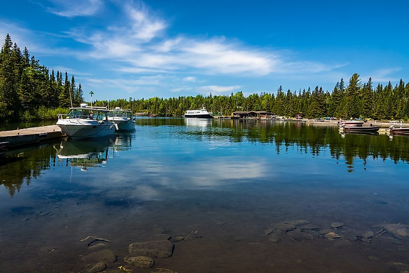 Boats rest on calm water at Rock Harbor in Isle Royale National Park.