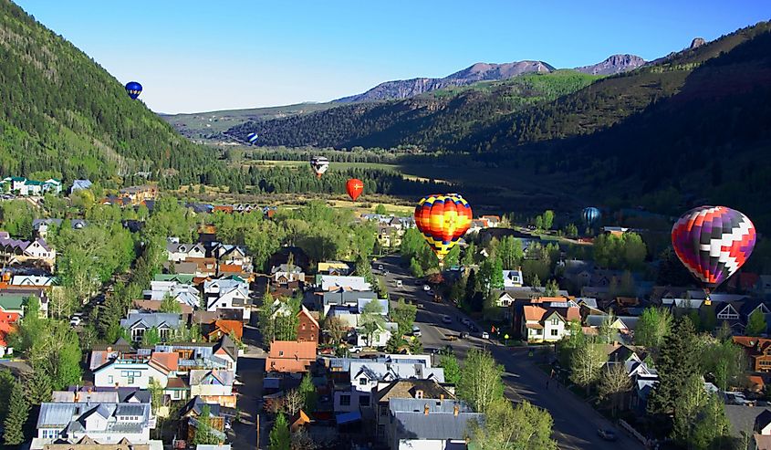 Balloon festival in Telluride. Hot Air balloons flying over town in the morning, Telluride, Colorado.