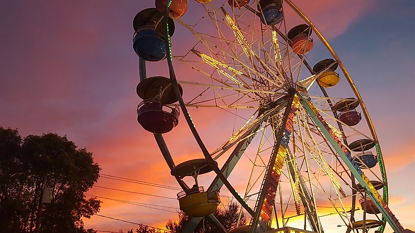 A beautiful view of a Ferris Wheel at the Farmington Fair. Captured on a cold fall night, accompanied by a beautiful sunset.