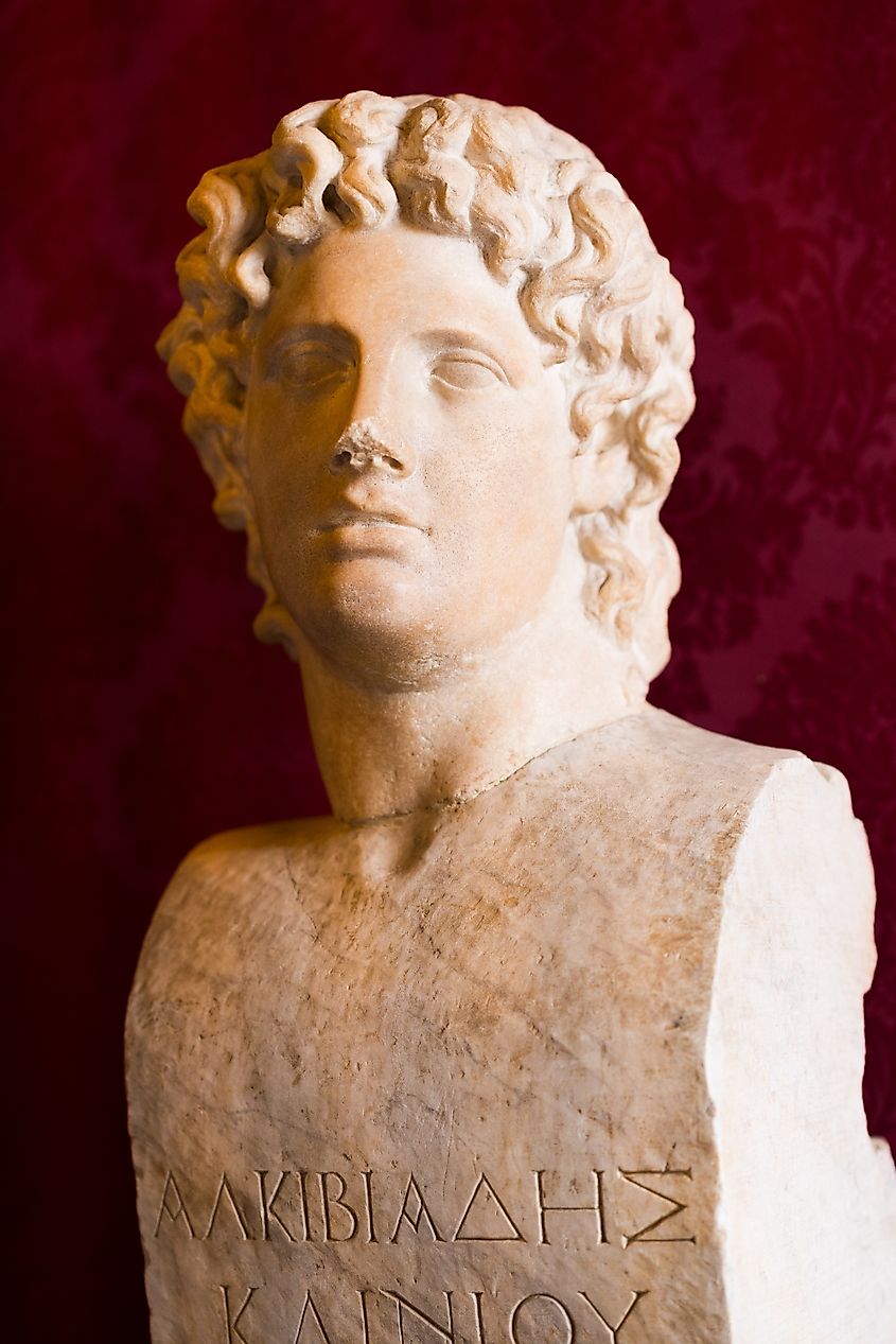Greek marble bust of Alcibiades against rich red backdrop for historical display at Capitoline Museums. Via Shutterstock / photo-lime