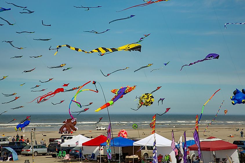 Many kites in the air and exhibitor's tents on the beach at the Washington State International Kite Festival at Long Beach, via Bob Pool / Shutterstock.com