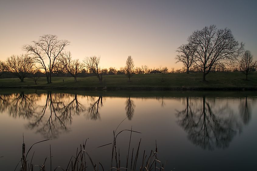 Franzen Lake in Villa Hills, Kentucky, with a calm water surface reflecting the surrounding trees and landscape