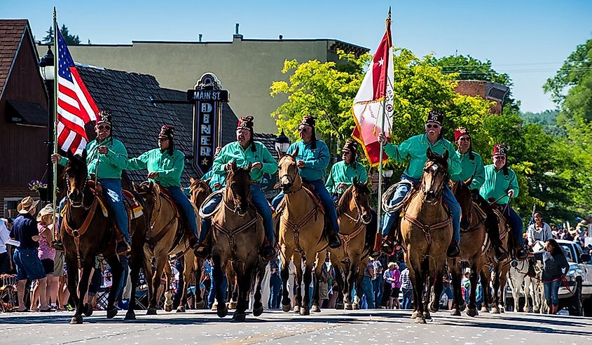 Horses and American flags at the Longmire Days Parade, Buffalo, Wyoming.