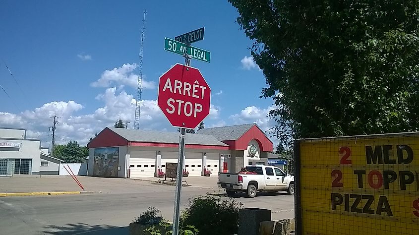 Bilingual French/English stop sign and street signs at 50th Street and 50th Avenue in Legal, Alberta