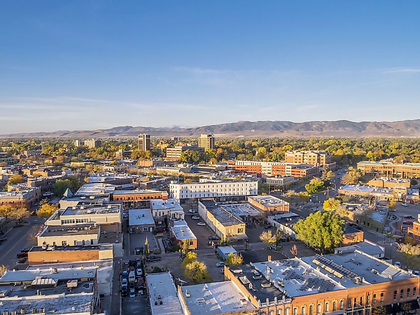 Aerial view of Fort Collins downtown in sunrise light, with Rocky Mountain foothills in the background