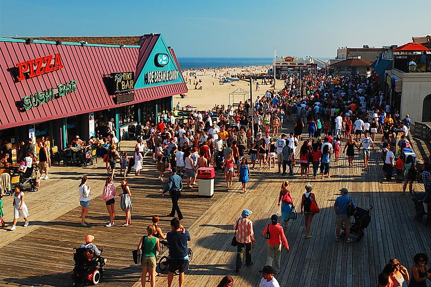 A large crowd enjoying a sunny day on the Point Pleasant, New Jersey boardwalk.