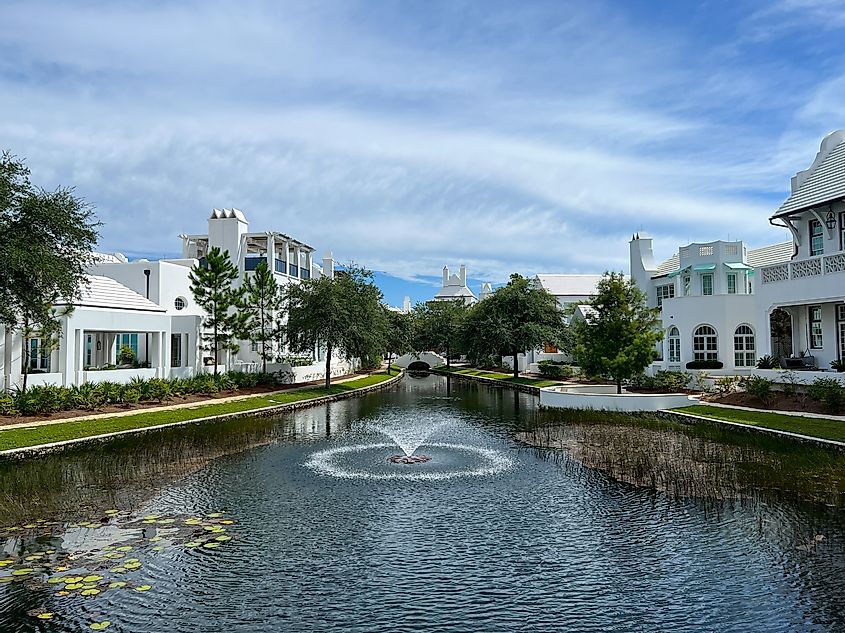 A walking path with water feature and homes in Alys Beach, Florida.