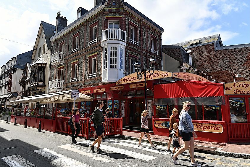 A street in Etretat filled with tourists.