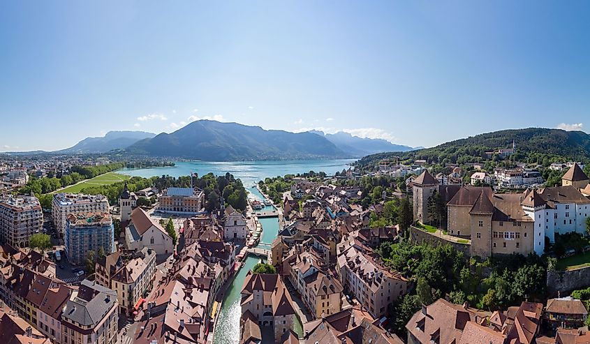 Annecy city center panoramic aerial view with the old town, castle, Thiou river and mountains surrounding the lake, beautiful summer vacation tourism destination in France