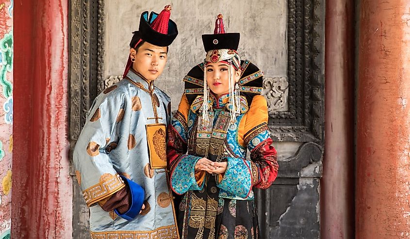 Young Mongolian couple in a traditional 13th century costume in a temple. Ulaanbaatar, Mongolia.