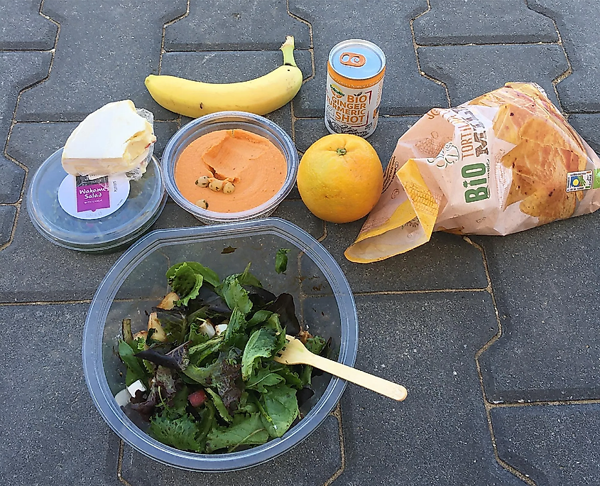 A collection of healthy foods laid out on the pavement.