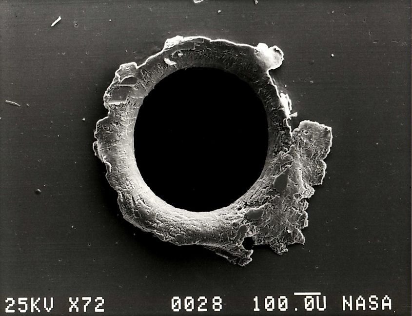 View of an orbital debris hole made in the panel of the Solar Max satellite