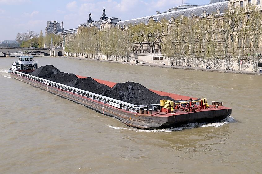 Coal barge and tugboat on the Seine River, Paris, Île-de-France, France
