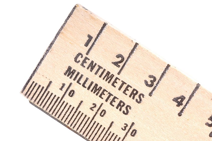 Wooden ruler with centimeters and millimeters.