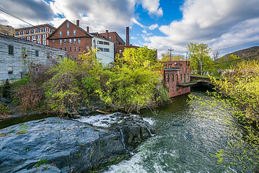 Scenic view of cascades along Whetstone Brook, flanked by old buildings in Brattleboro, Vermont.