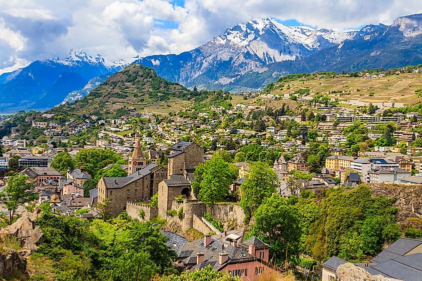 View over the city of Sion with the Swiss Alps behind, canton of Valais, Switzerland.